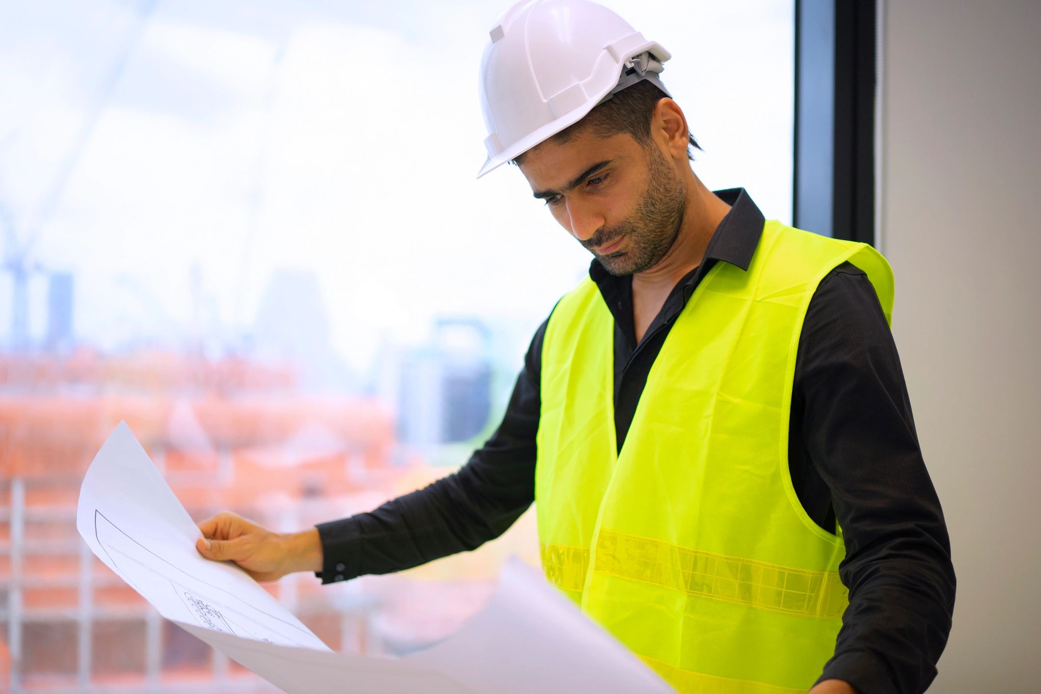 Engineer reviewing a project at an active worksite